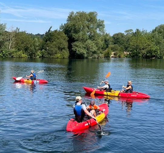 Group in Kayaks on Water
